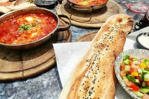 Shakshuka - traditional Israeli tomato stew with egg. photo