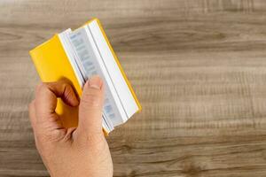 Hand holding a small book. photo