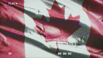 VHS video casette record Canada flag waving on the wind. Glitch noise with time counter recording Canadian banner swaying on the breeze. Seamless loop.