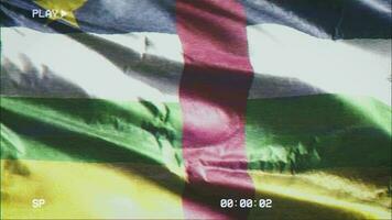 VHS video casette record Central African Republic flag waving on the wind. Glitch noise with time counter recording banner swaying on the breeze. Seamless loop.