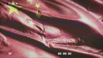 VHS video casette record China flag waving on the wind. Glitch noise with time counter recording Chinese banner swaying on the breeze. Seamless loop.