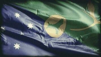 Retro aged Christmas Island flag waving on the wind. Old vintage banner swaying on the breeze. Seamless loop. video