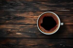 Cup of coffee on wooden background. Top view with copy space. photo