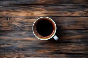 Cup of coffee on wooden background. Top view with copy space. photo