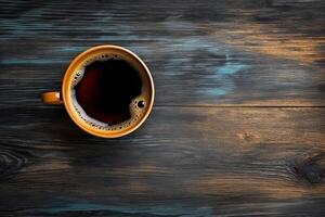 Cup of coffee on wooden background. Top view with copy space. photo