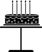 Black and white decorated cake with burning candles. Glyph icon or symbol. vector