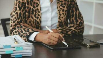 Asian Business woman using calculator and laptop for doing math finance on an office desk, tax, report, accounting, statistics, and analytical research concept video