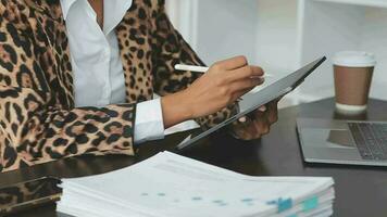 Asian Business woman using calculator and laptop for doing math finance on an office desk, tax, report, accounting, statistics, and analytical research concept video