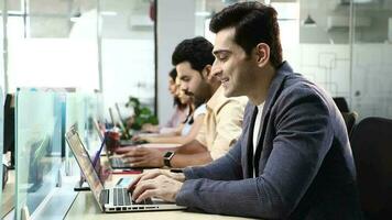 Video of Business People sitting in row working on laptop in office