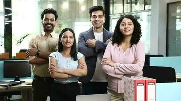 Video of colleagues standing in front of camera with arms folded