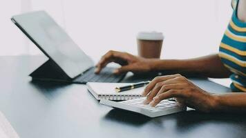 Portrait of Asian young female working on laptop at office video