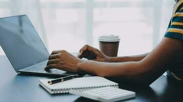 Portrait of Asian young female working on laptop at office video