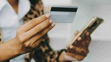 Women holding credit card and using smartphones at home.Online shopping, internet banking, store online, payment, spending money, e-commerce payment at the store, credit card, concept video