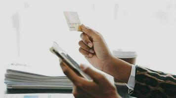 donne Tenere credito carta e utilizzando smartphone a casa.online acquisti, Internet bancario, memorizzare in linea, pagamento, la spesa i soldi, e-commerce pagamento a il negozio, credito carta, concetto video