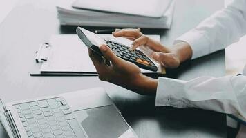 Asian Business woman using calculator and laptop for doing math finance on an office desk, tax, report, accounting, statistics, and analytical research concept video