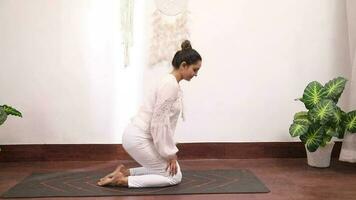 Video of woman sitting in Vajrasana pose.