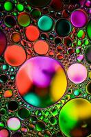 multi colored oil circles on the water, colorful background photo