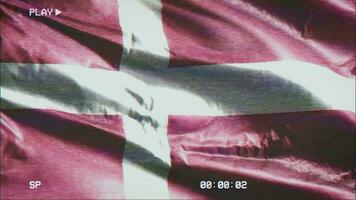 VHS video casette record Denmark flag waving on the wind. Glitch noise with time counter recording banner swaying on the breeze. Seamless loop.