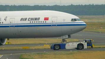 FRANKFURT AM MAIN, GERMANY JULY 17, 2017 - Air China Boeing 777 B 7952 towing by tractor from service. Fraport, Frankfurt, Germany video