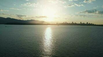 Vancouver skyline silhouettes in beautiful morning light, aerial view video