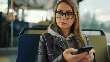 Public transport. Woman in tram using smartphone video