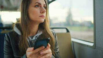 Public transport. Woman in tram using smartphone video