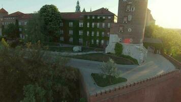 Aerial view of Wawel royal Castle and Cathedral early morning at dawn. Panorama of the city is visible in the background video