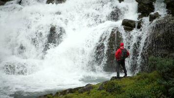 Exploring the Nature. Caucasian Men in Front of Scenic Norwegian Waterfall video