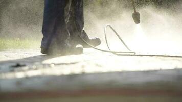 Garden Patio Pressure Washing by Caucasian Men Using Pressure Washer. video