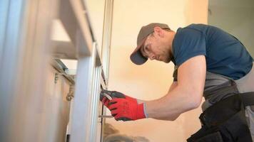 Caucasian Sanitary Plumbing Installer in His 30s Installing Bathroom Equipment. video