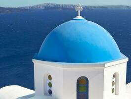 Traditional blue cupola in Oia, Santorini photo