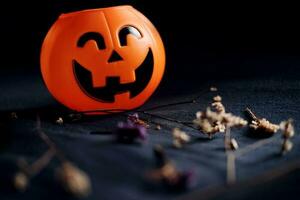 Halloween pumpkin head with dry flowers on black clothes in natural shadow and light. Halloween holiday concept. photo