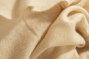 Natural wool creamy colored fabric. Cashmere, wool. Texture of natural wool fabric. Knitwear. photo