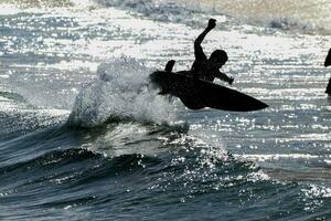 Rio de Janeiro, RJ, Brazil, 05.08.2023 - Surfers riding waves on Arpoador Beach, Ipanema photo