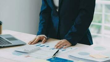 business documents on office table with smart phone and digital tablet and graph financial with social network diagram and man working in the background video
