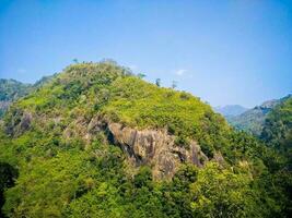 A mountain with a green tree on it Jhum cultivation , amiakum, nafakum, bandarban bangladesh. photo