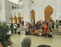 solo - 2 junio de 2023 - un grupo de visitantes tomando selfies en frente de el blanco mezquita foto