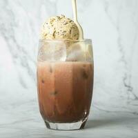 Pour the almond milk cream. Iced cocoa with vanilla ice cream in clear glass on marble Copy space for your text. square image photo