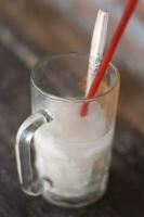 Es Kelapa Muda or young coconut ice, in a glass glass is a popular Indonesian drink. photo