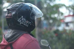 Magelang District, Central Java, Indonesia - April 21, 2023 -NhK, the leading helmet brand in Indonesia, is the most commonly encountered on the road. photo