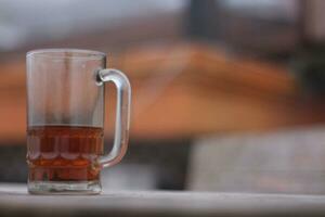 Glass of hot tea against a background of thick fog on a dry summer day. photo