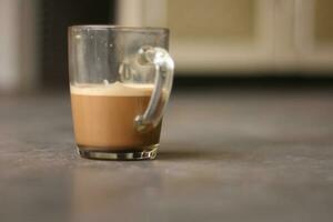 cappuccino coffee with choco grandul in a transparent cup photo