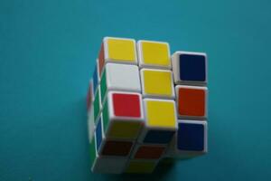 Magelang,Indonesia.june 4, 2023-Colorful Rubik's cube isolated on blue background, close up photo