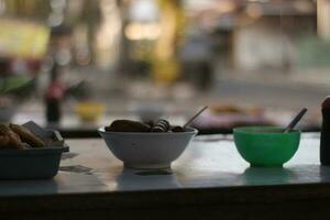 3 different bowls containing various side dishes for the main menu at the soto stall. photo