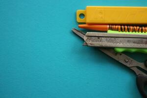 assorted school stationery isolated on blue background. photo