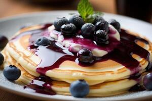 stock photo of warm pancake with blueberry syrup food photography