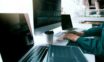 Asian man working code program developer computer web development working design software on desk in office. photo