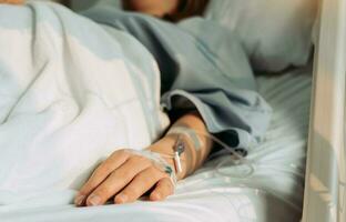 Asian woman lying sick in hospital. photo