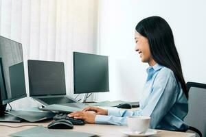 Asian young female programmer working developer programing on a computer code at office. photo