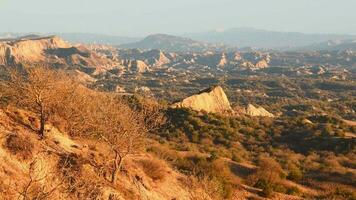 Surreal dramatic deserted earth landscape panorama with beautiful cliff formations and golden sunset background in Vashlovani national park. Travel Georgia destination. video